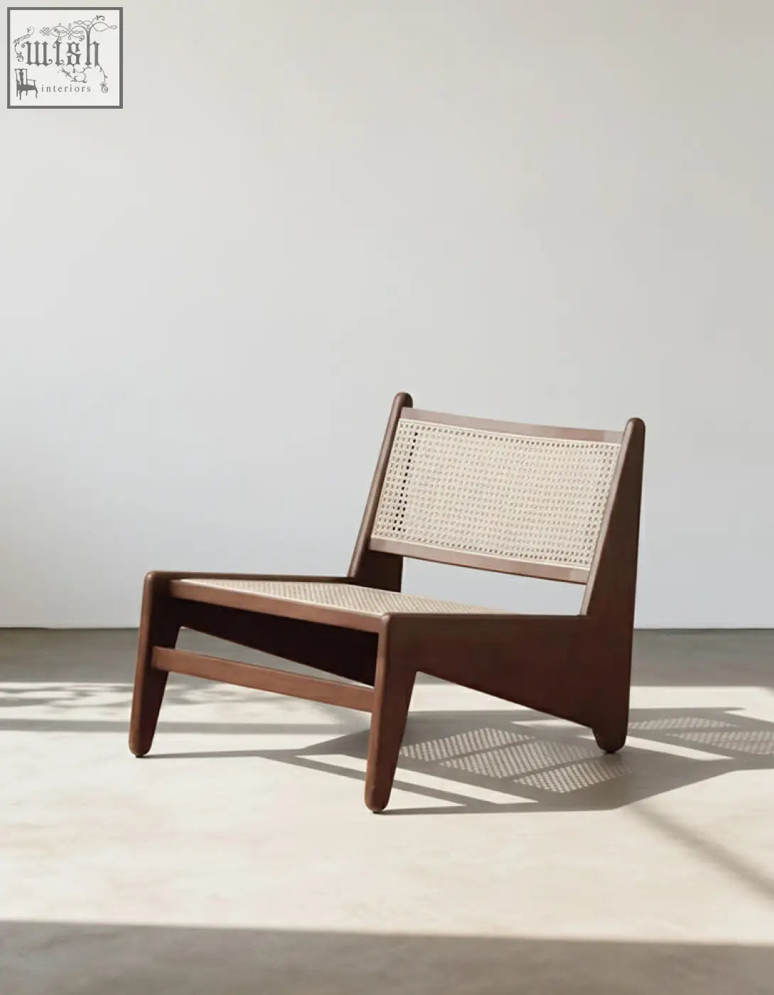 Minimalist tracyh lounge chair with rich brown wooden frame and light beige woven rattan cane seat and back