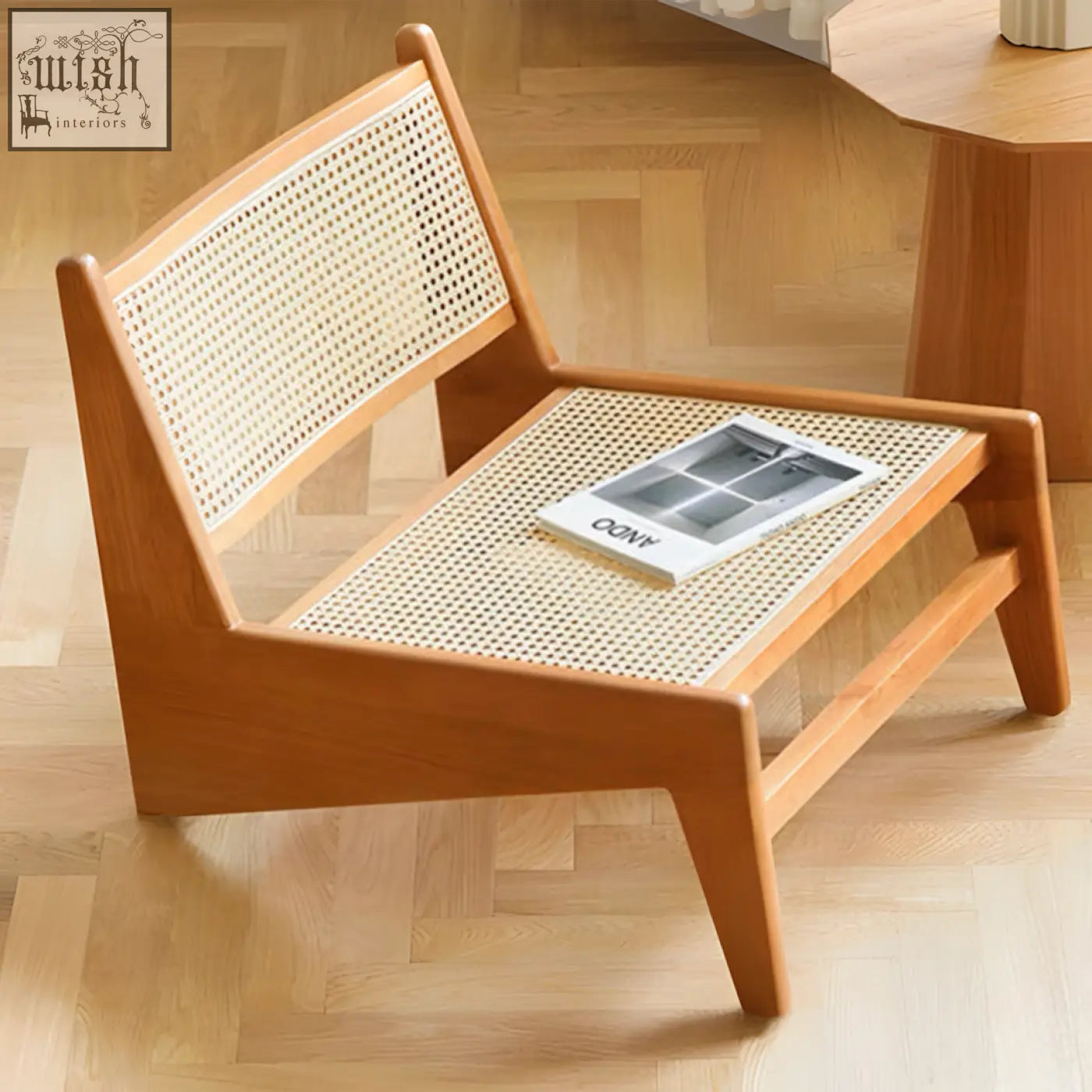 Minimalist tracyh lounge chair with light brown wooden frame and woven rattan seat and back perfect as a lounge chair