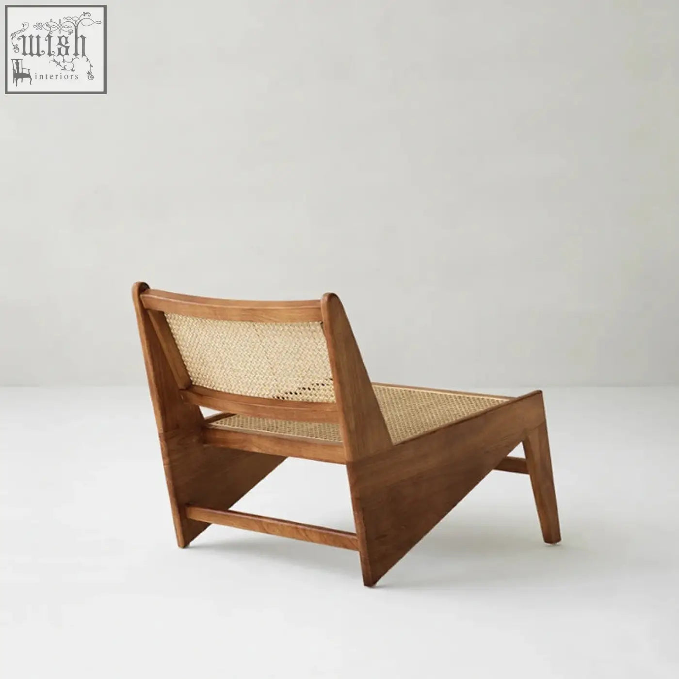 Minimalist tracyh lounge chair in warm brown wood with woven rattan cane back and seat for cozy lounging