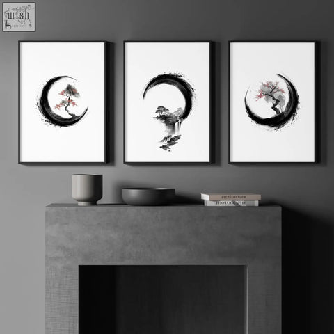 Three minimalist black-framed japanese wall art ink wash prints of trees in crescent shapes above a concrete mantel