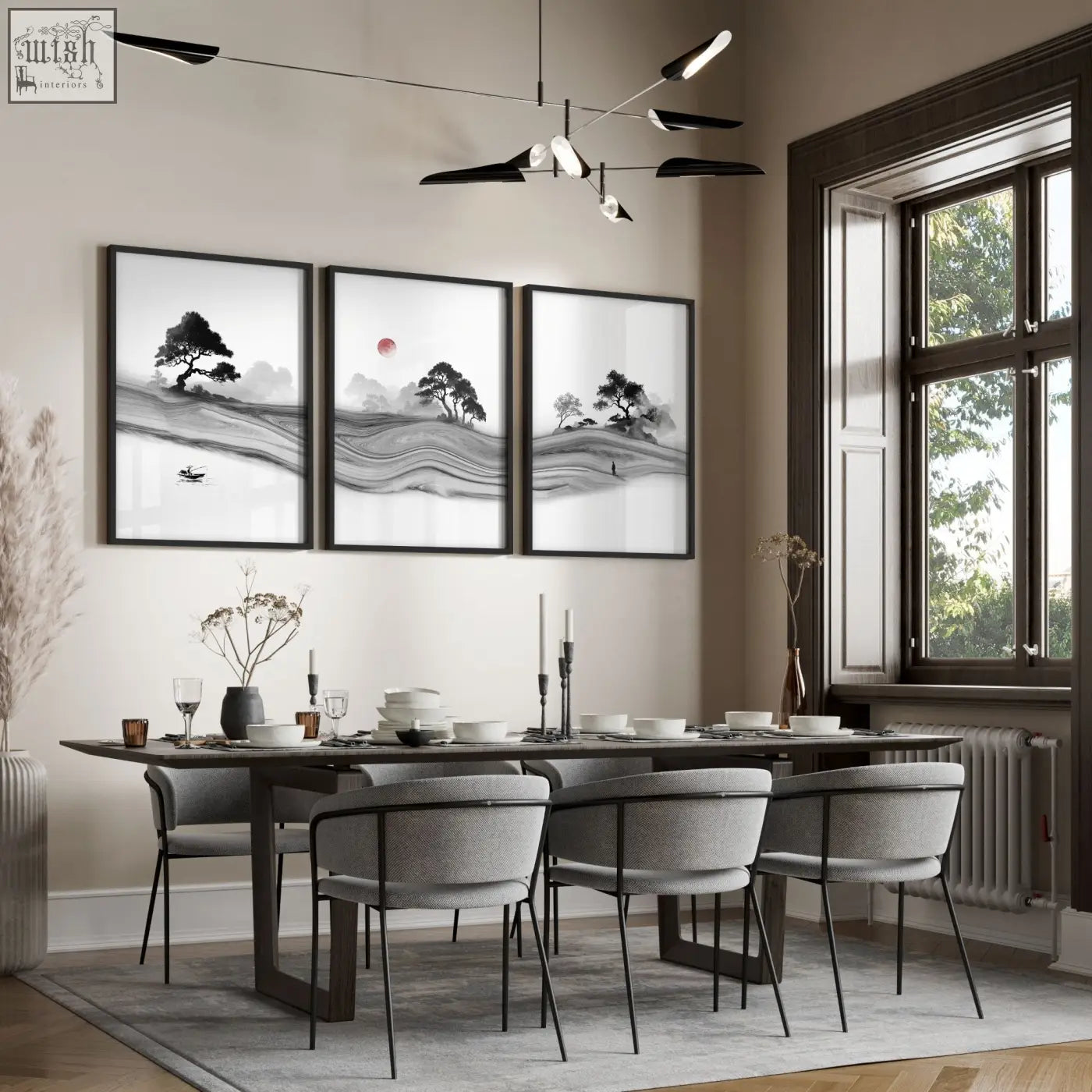 Three framed black and white traditional japanese wall art prints with ink landscape and red moon above dining table