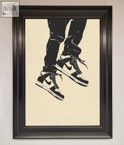 Stylized black and white nike dunk low trainers bouncing framed wall art in a dark frame perfect for sneaker fans