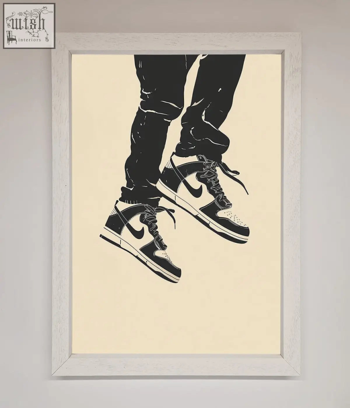 Black and white nike dunk low trainers bouncing framed wall art with classic swoosh in light wood frame