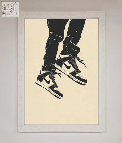 Black and white nike dunk low trainers bouncing framed wall art with classic swoosh in light wood frame