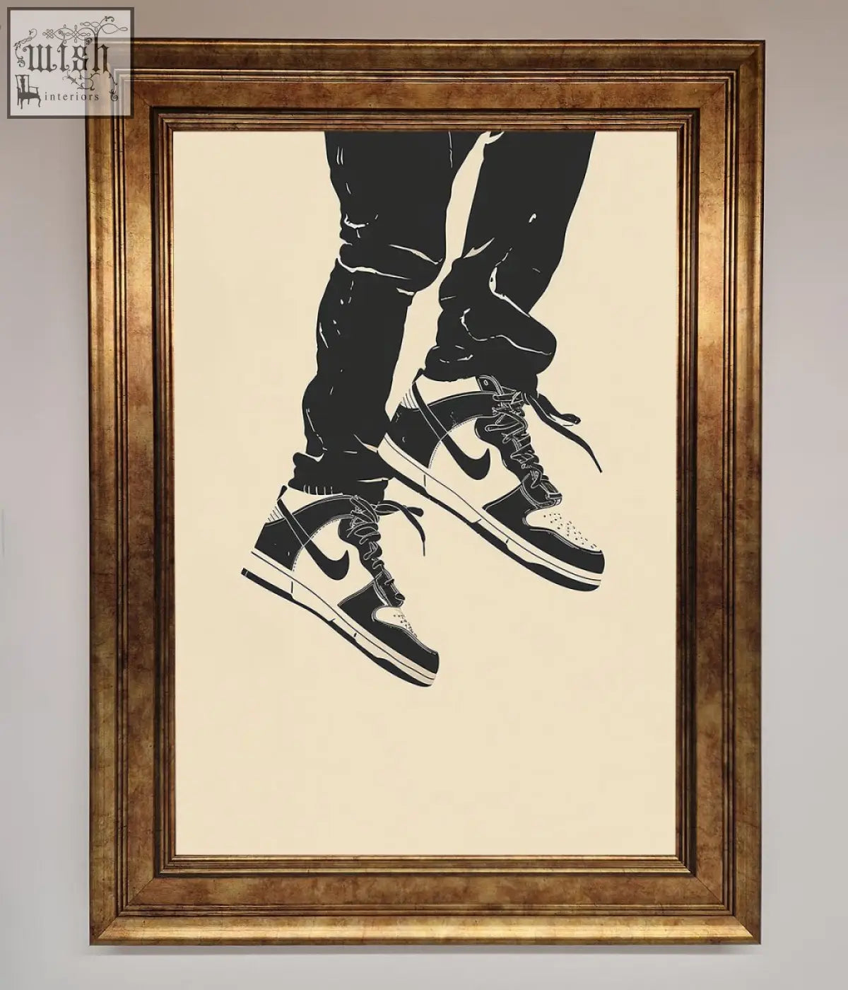 Black and white nike dunk low trainers bouncing framed wall art with classic swoosh in ornate gold frame