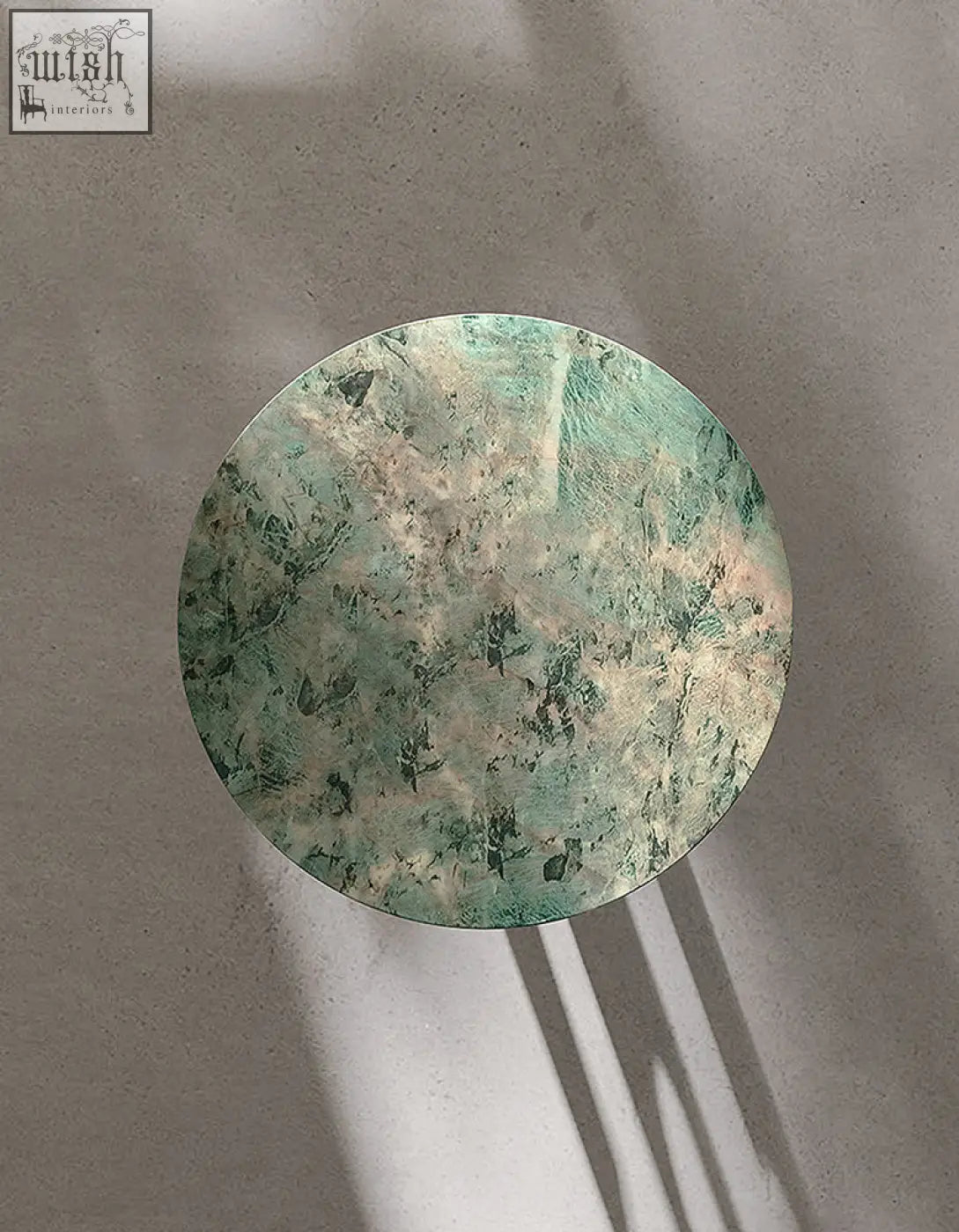 Circular tran side table with mottled green and beige marble surface offers financing and low shipping cost options