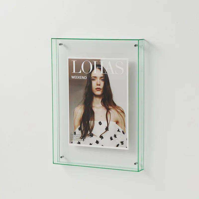 Clear glass wall-mounted transparent acrylic picture frame holding a lohas magazine in an acrylic picture frame