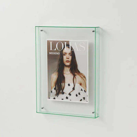 Clear glass wall-mounted transparent acrylic picture frame holding a lohas magazine in an acrylic picture frame