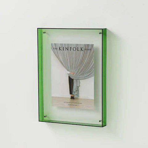 A translucent green transparent acrylic picture frame holding a copy of kinfolk home magazine