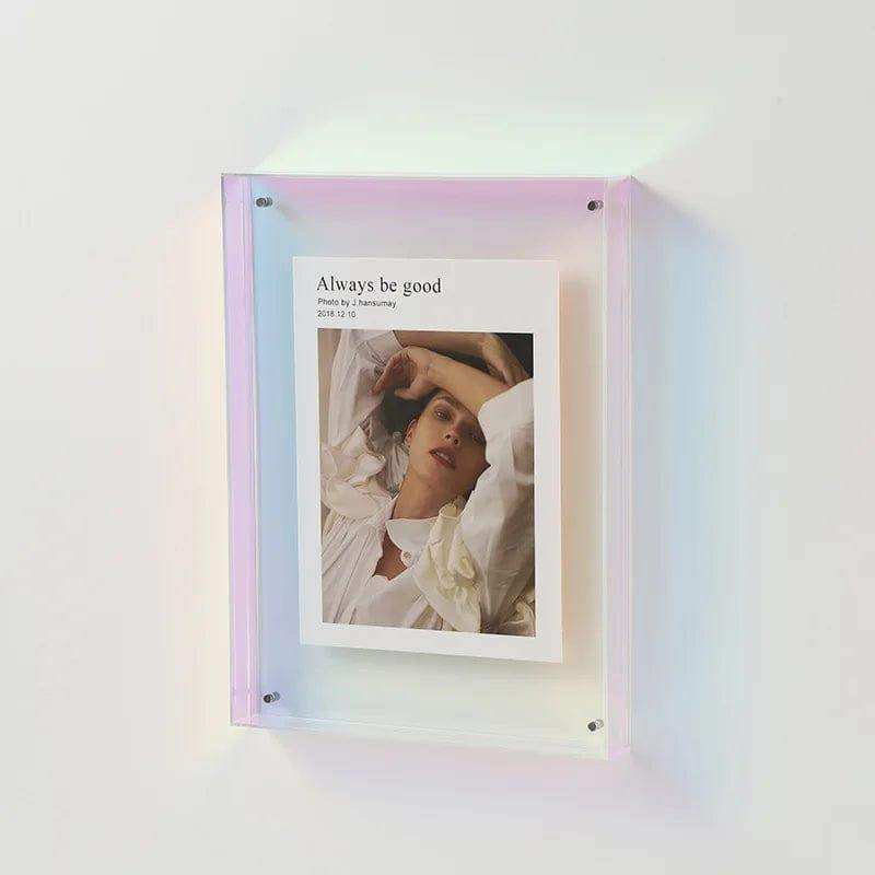 A transparent acrylic picture frame with a translucent iridescent pastel gradient border holding a photo