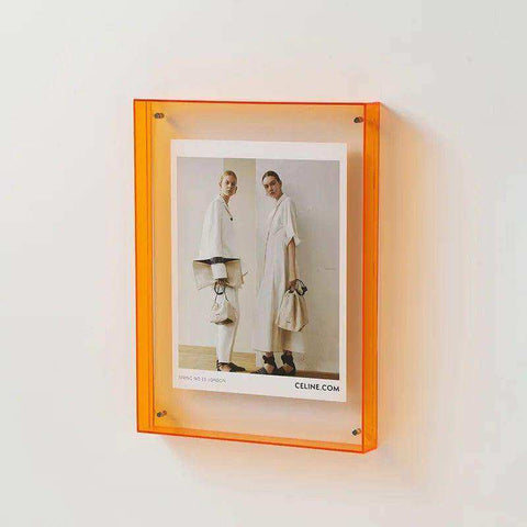Vibrant orange transparent acrylic picture frame with minimalist design and four metallic corner fasteners acrylic picture frame