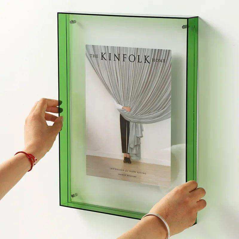 Green transparent acrylic picture frame wall-mounted display case holding a magazine with acrylic picture frame design