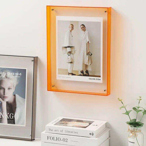 Vibrant orange acrylic picture frame with transparent acrylic border and corner screws for secure mounting