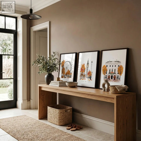 Three framed autumnal london cityscape watercolor prints with black frames on a wooden console for travel room decor