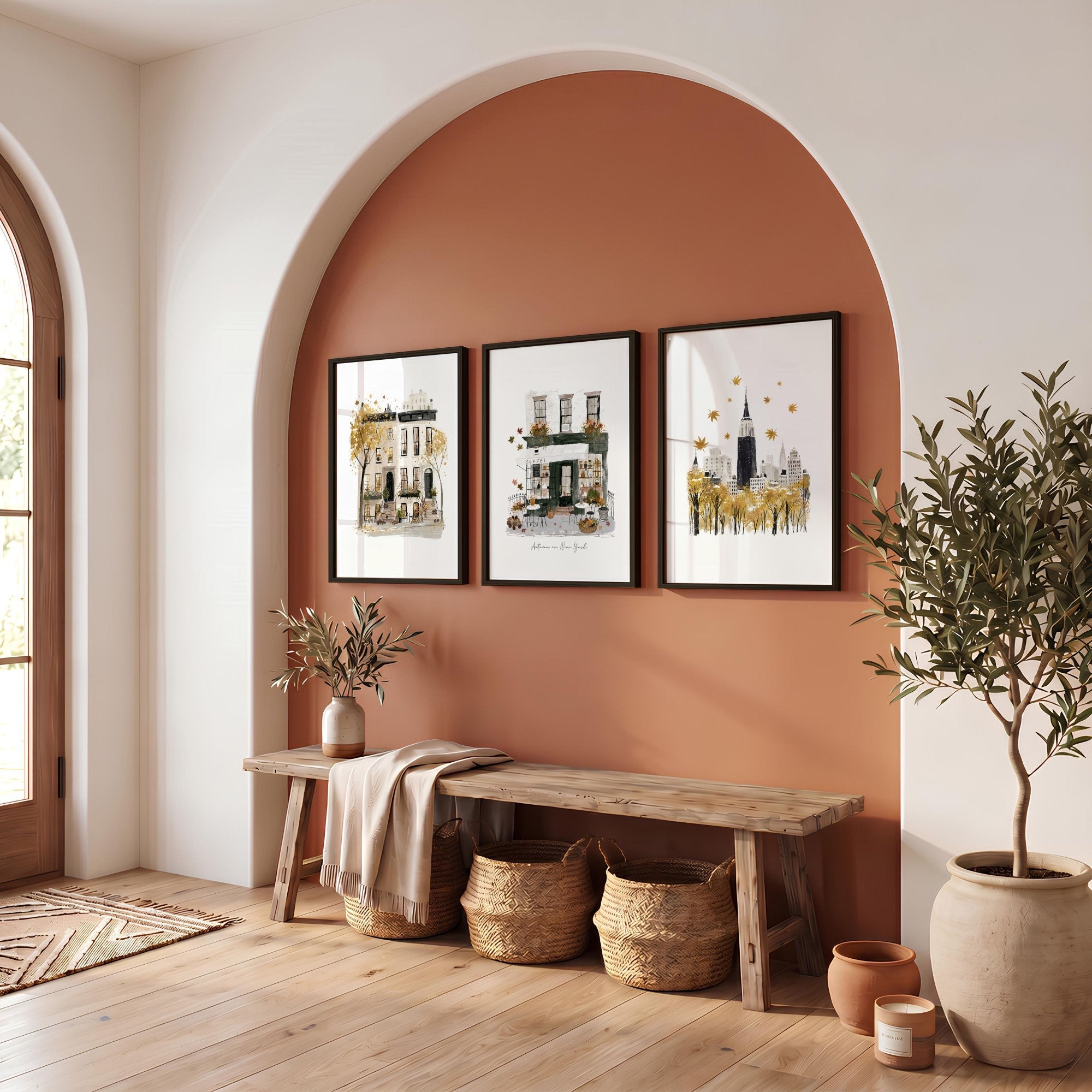 Three framed new york travel wall art prints with ochre watercolor cityscapes hang above a rustic wooden bench