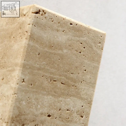Beige travertine wall light block with natural veining and porous texture perfect for indoor outdoor use