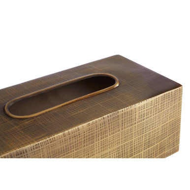 Trae tissue box with bronze finish and textured woven surface featuring an elongated oval opening for tissues