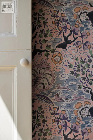 Pink vintage french tree of life wallpaper with intricate black green and orange birds clouds and foliage patterns