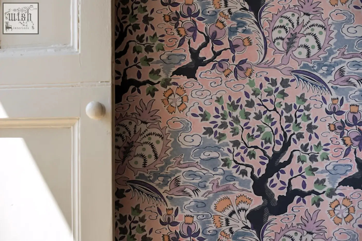 Pink wallpaper with vintage french inspired intricate black green and orange floral tree of life pattern