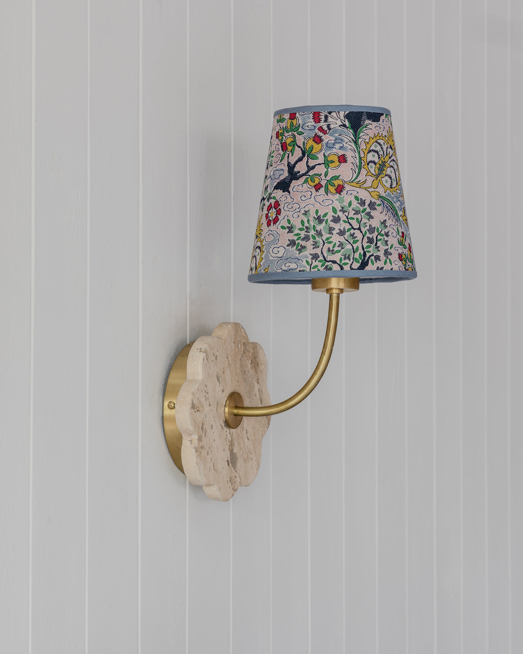 Tree of life lampshade wall sconce with brass arm and scalloped light stone backplate with colorful floral fabric shade
