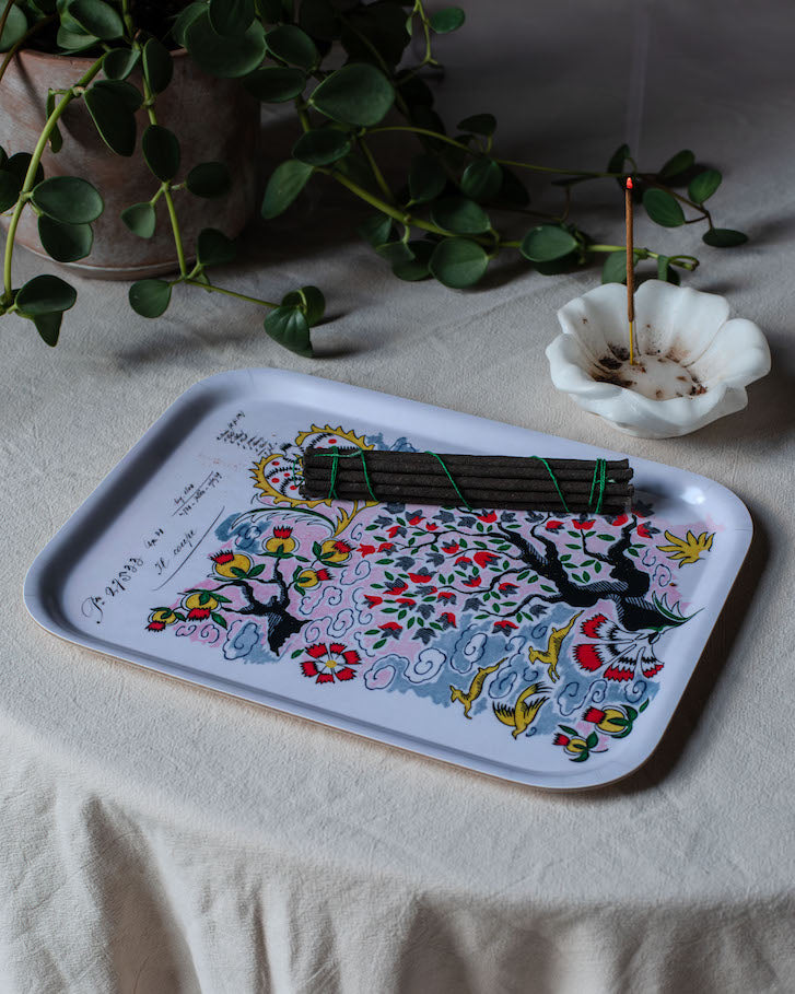 Tree of life wooden tray with colorful floral and bird design in pink red yellow and blue on white rectangular tray