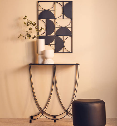 Black metal console table with curved cable-like legs and grey glass top from trento black console collection