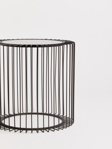 Trento black metal round side table with a black cylindrical wireframe base and clear glass top