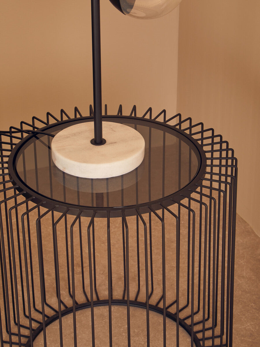 Trento black metal round side table with circular glass top and white marble base in wireframe design