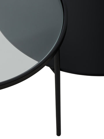Black circular trento coffee table with glass and metal tops and thin metal legs for lower level use