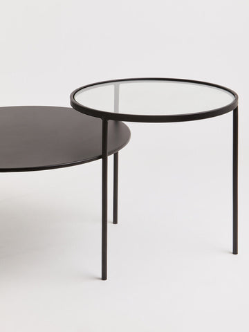 Black metal-framed trento coffee table with clear glass top and lower level shelf for stylish living room use