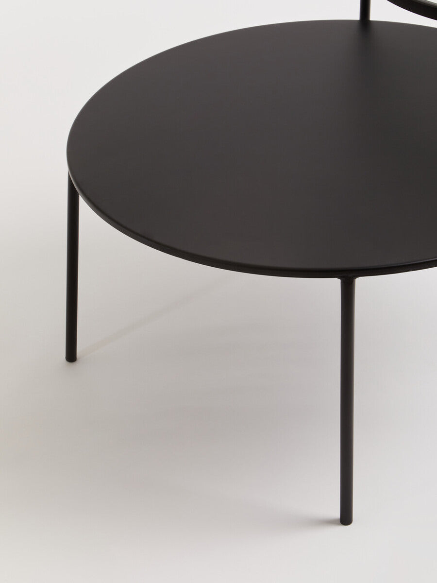 Black round trento coffee table with glass and metal tops and slender metal legs for lower level use