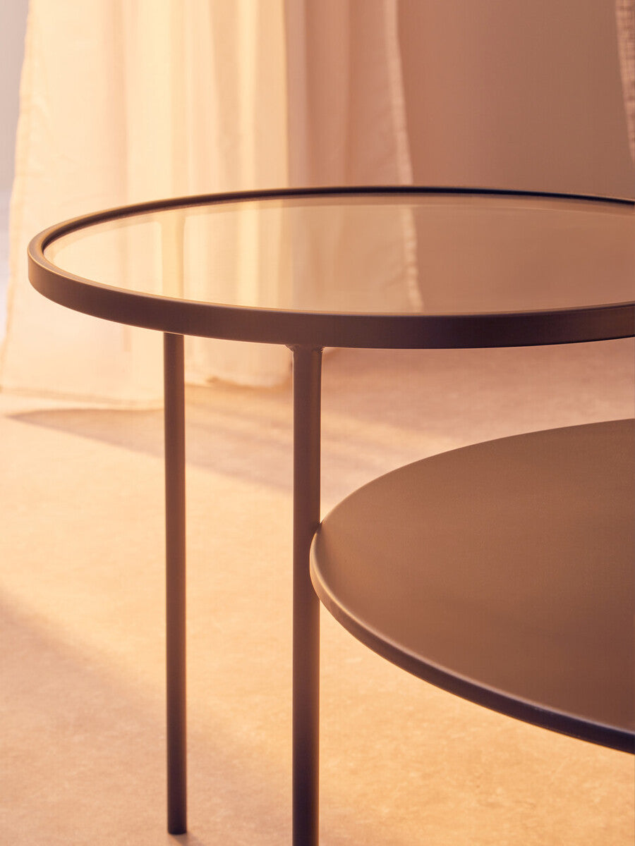 Modern trento coffee table with glass and metal tops featuring a sleek black frame and a lower level shelf for storage