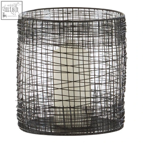 Black wire mesh cylindrical lantern with a white pillar candle inside trento cylindrical lantern design