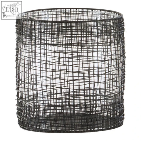 Black wire mesh cylindrical basket of the trento cylindrical lantern for stylish candle display and ambient lighting