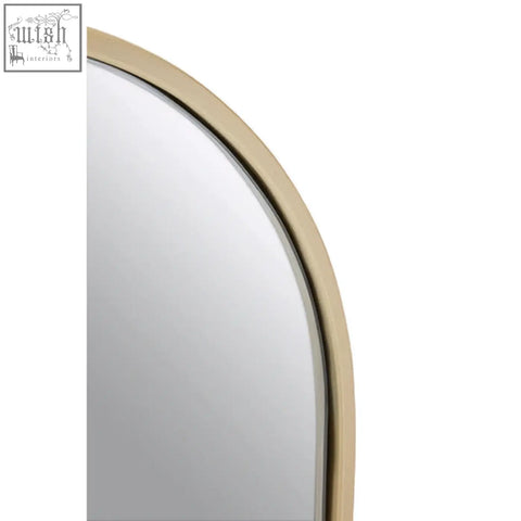 A sleek trento gold frame large arch wall mirror with a polished gold frame and curved design