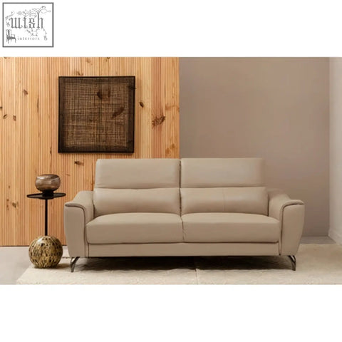Beige leather sofa with clean lines and modern design placed near trento metal cross wires design wall art