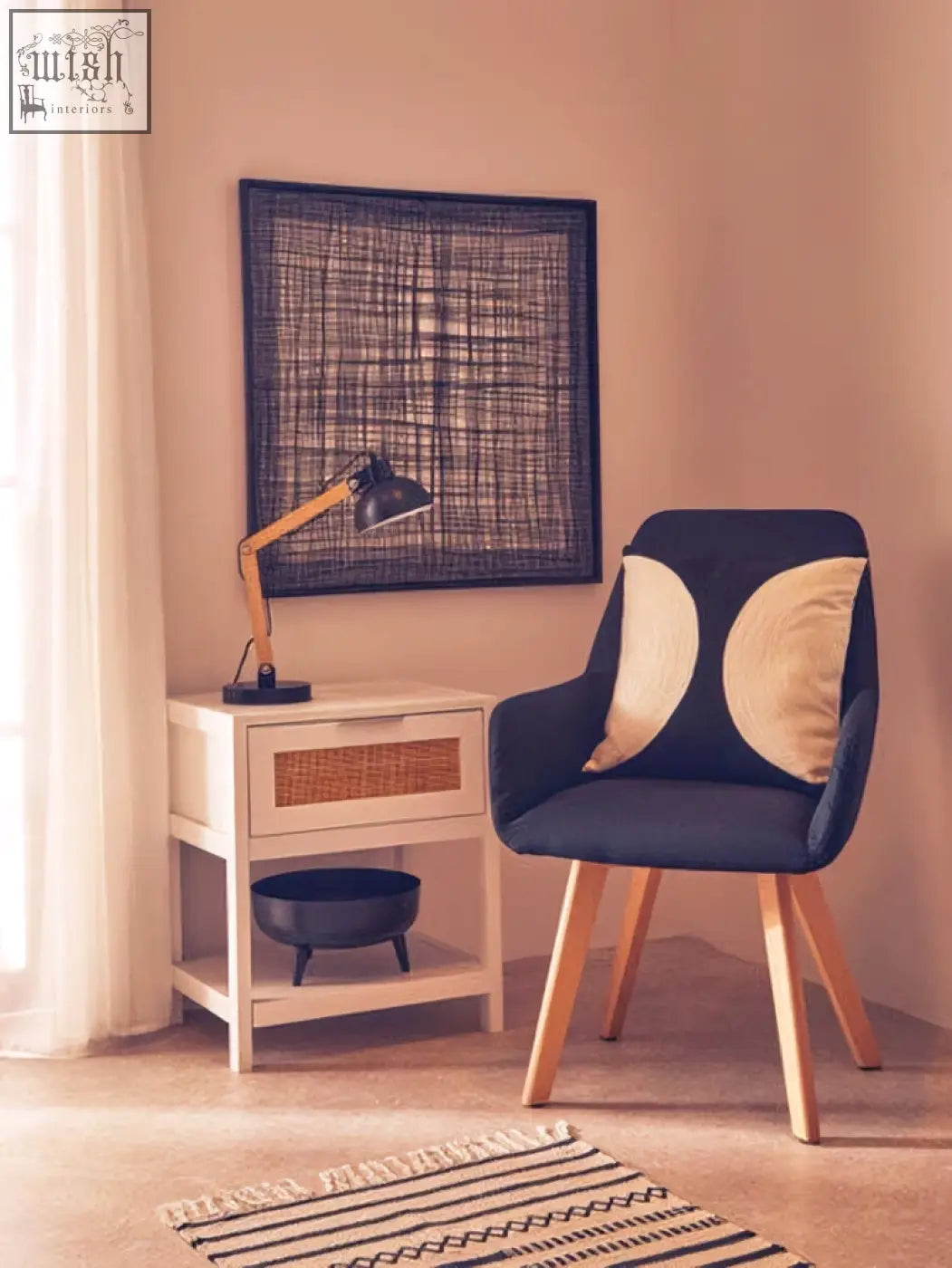 Navy blue armchair with cream circular pillows next to trento metal cross wires design wall art in wires design wall style