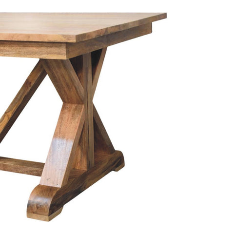Rustic wooden treston dining table with natural finish and x-shaped base perfect for cozy dining spaces