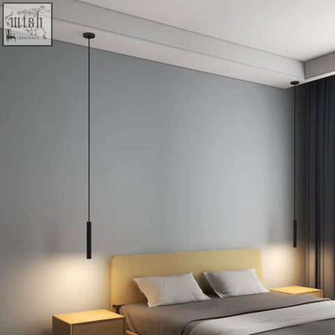 Black pendant light with sleek cylindrical design hanging from ceiling ideal for adjustable minimal bedroom lighting
