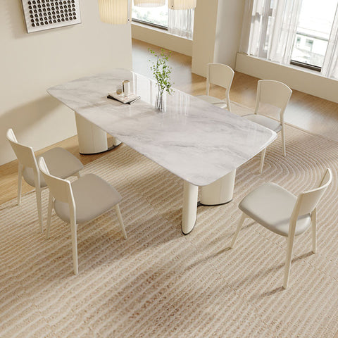 Modern white marble trish dining table with sleek curved legs and minimalist design perfect for dining spaces