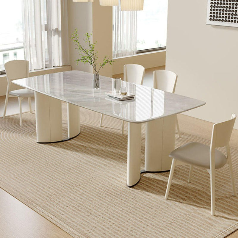 Modern white marble trish dining table with sleek curved cream-colored legs perfect for stylish dining table setups