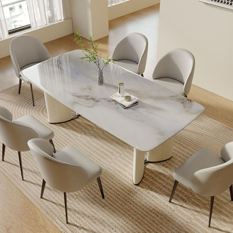 Modern white marble trish dining table with sleek curved cream legs and a minimalist design perfect for dining spaces