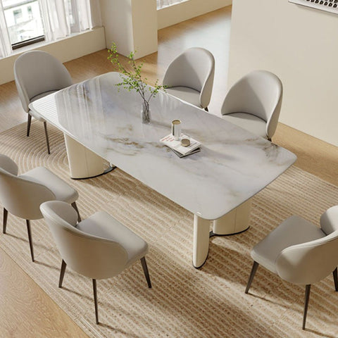 Modern white marble trish dining table with sleek curved cream legs and a minimalist design perfect for dining spaces