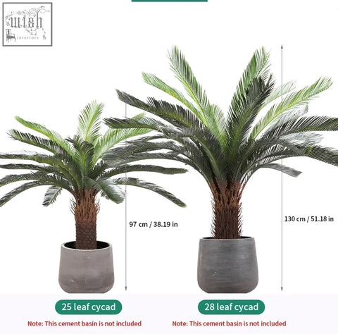 Two tropical artificial palm trees with plastic palm leaves in gray cement pots for home or office decor