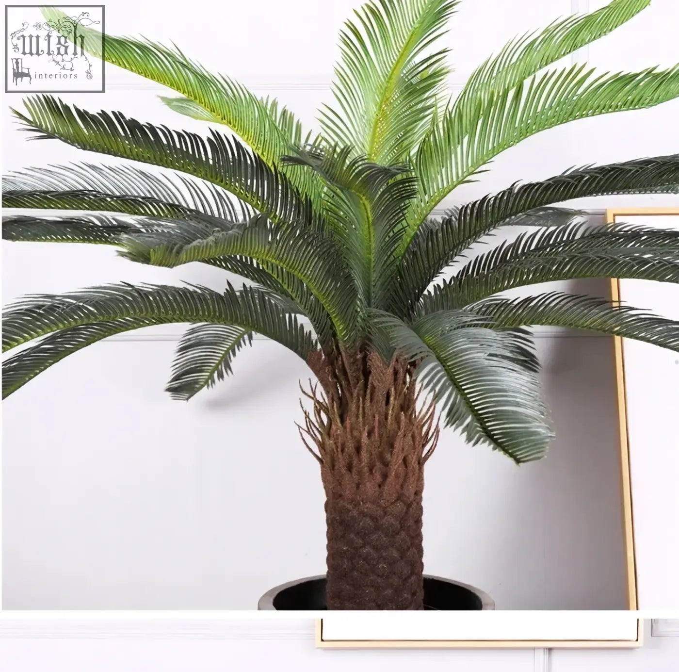 A lush tropical artificial palm tree with textured brown trunk and plastic palm leaves for home or office decor
