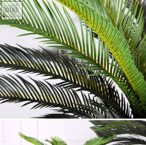 Tropical artificial palm tree with long slender green plastic palm leaves and realistic texture for home or office decor