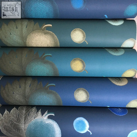 Rolls of blue and teal tropical fruit wallpaper with botanical design and textured metallic leaf patterns