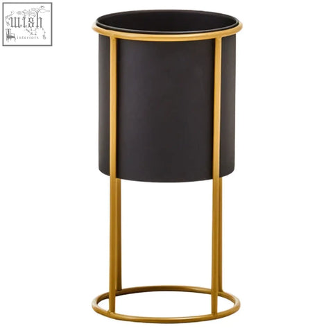 Trosa small black floor standing planter with gold metal frame and black cylindrical planter for indoor use