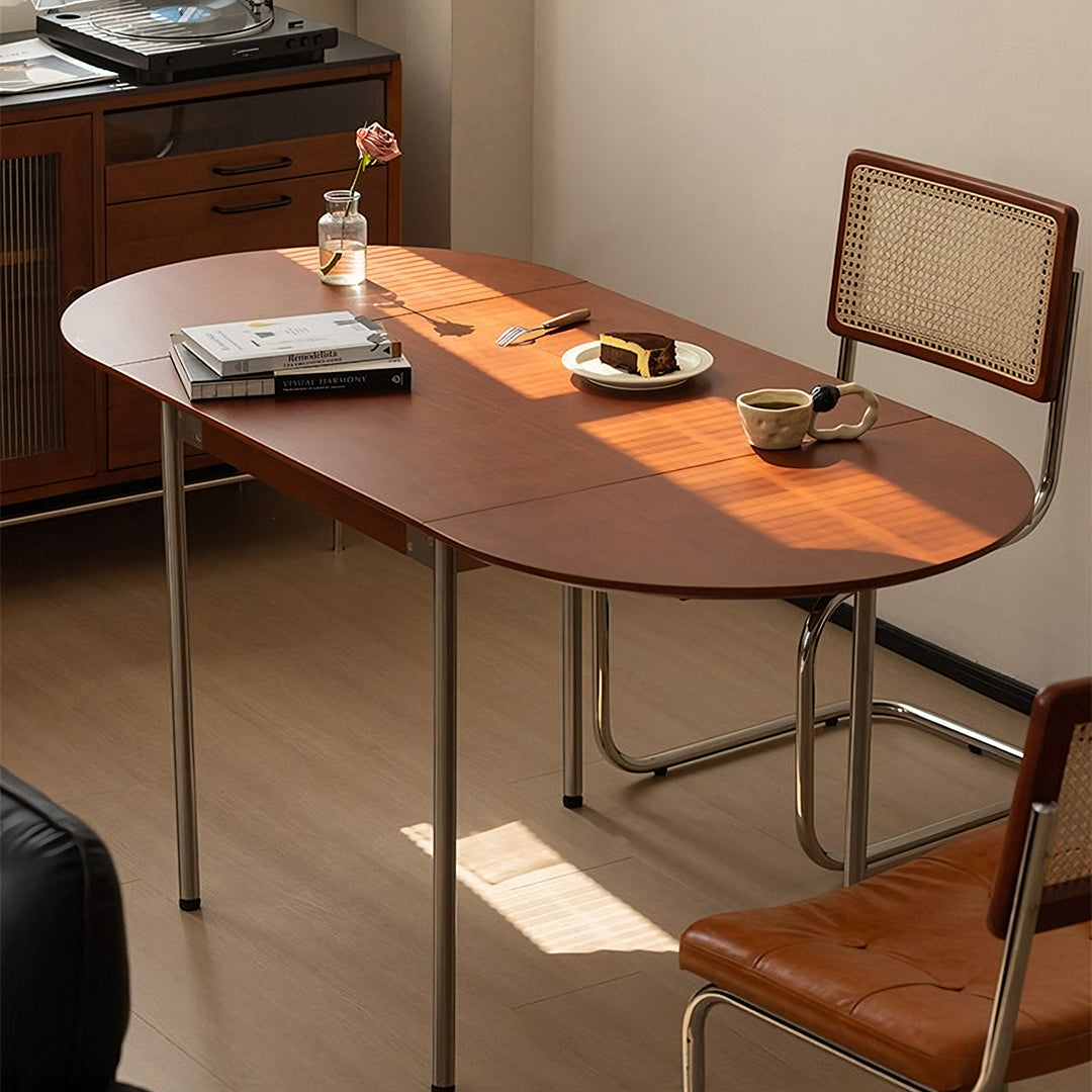Brown oval tsvetkov foldable dining table with solid wood top and metal legs for a sleek modern foldable dining table