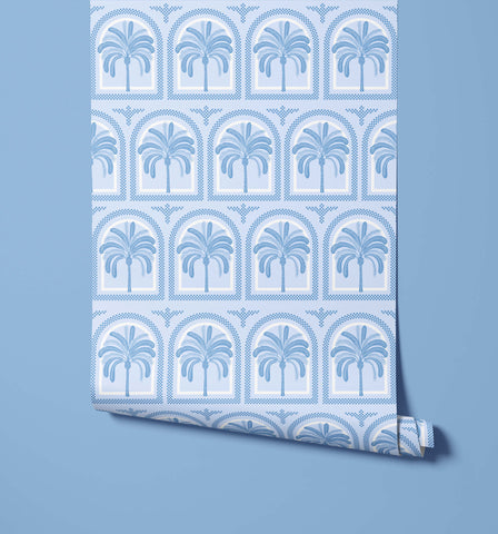 A roll of tucci light blue wallpaper with a repeating palm tree pattern in arched frames and subtle geometric details